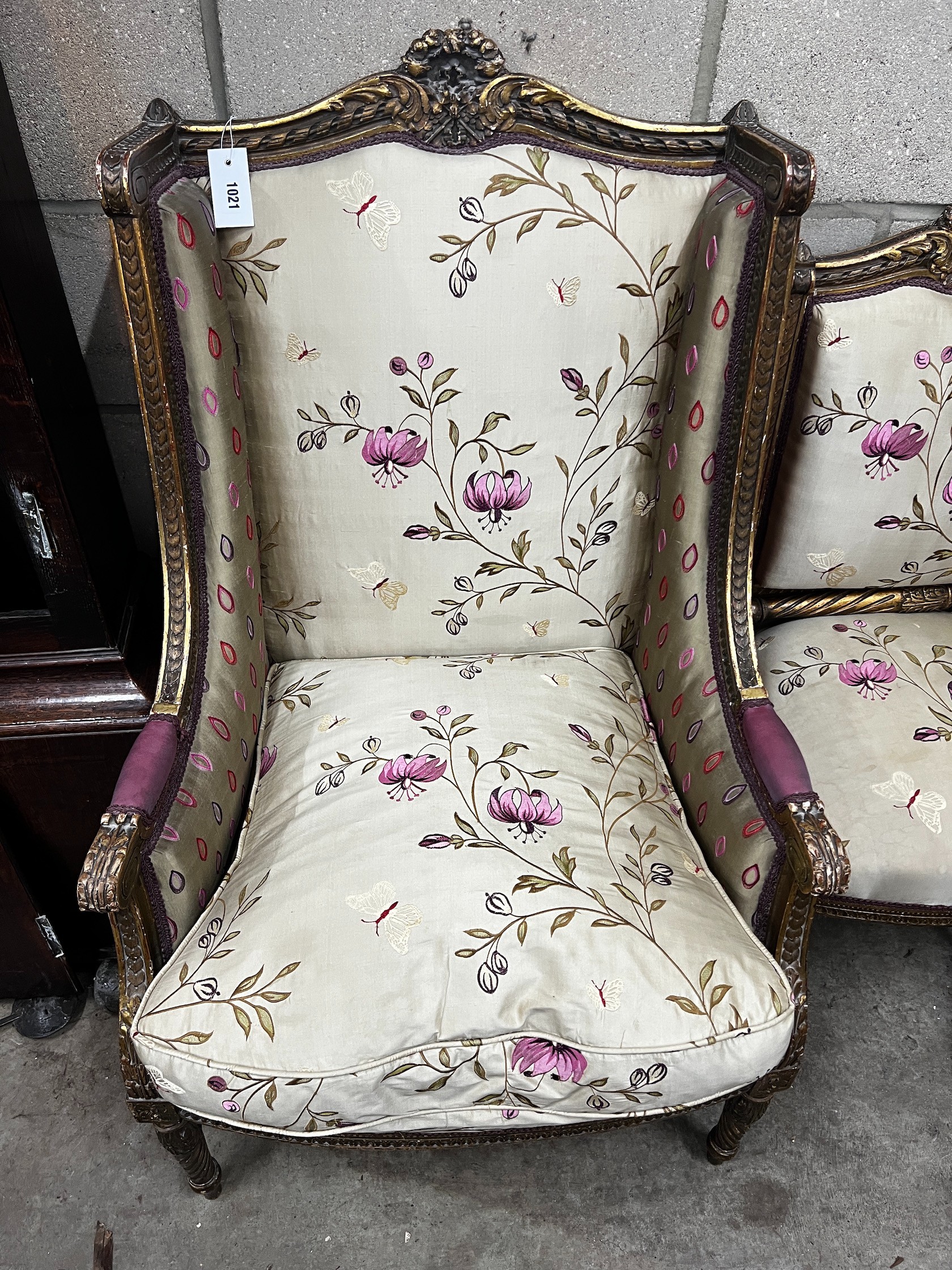 A late 19th century French carved giltwood and composition armchair, width 58cm depth 62cm height 104cm, with matching side chair